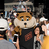 Image of an attendee taking a picture with Goldy Gopher.