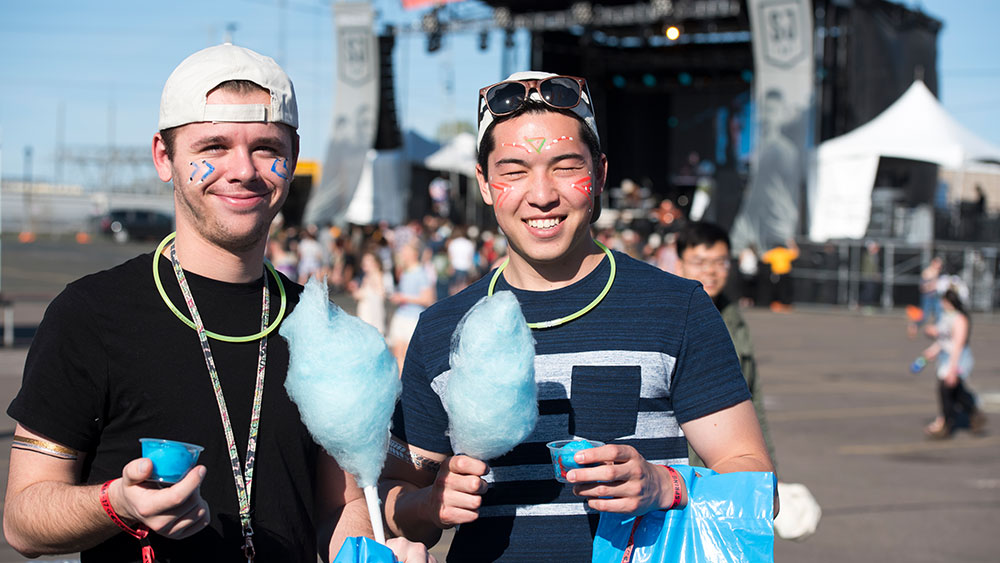 Image of attendees eating cotton candy.
