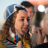 Image of an attendee getting their face painted.