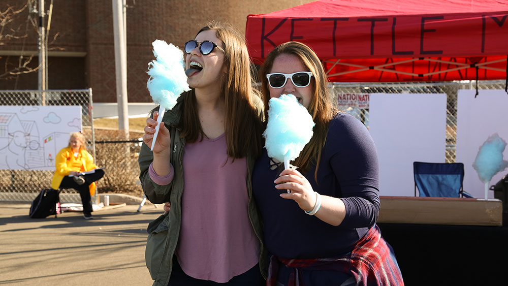 Image of attendees eating cotton candy.