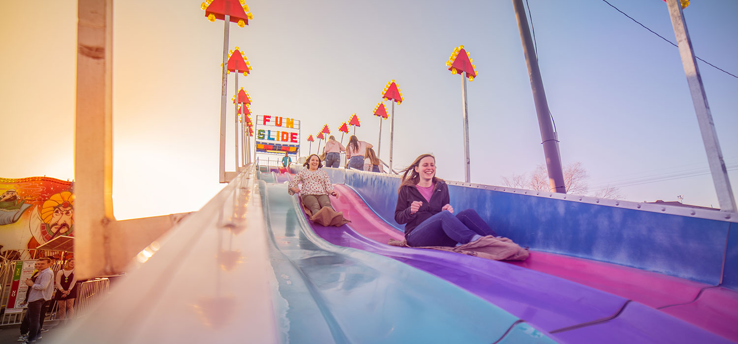 Woman having fun going down a giant slide