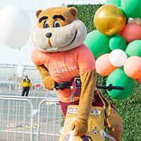 Image of Goldy on a scooter.