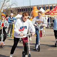 Image of attendees riding scooters.
