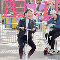Image of an attendee riding a scooter.