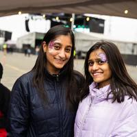 Friends posing in purple face paint at Spring Jam