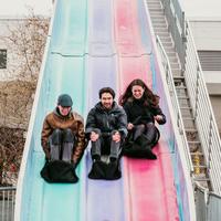 Students smiling while sliding down the "Fun Slide"