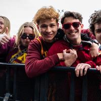 Students wearing gopher gear posing in the crowd